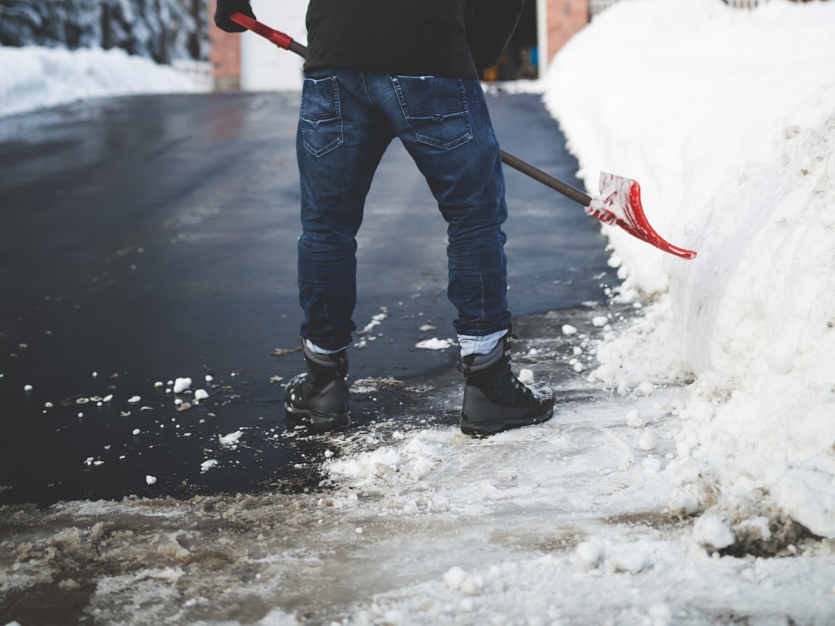 Person shoveling snow from a driveway